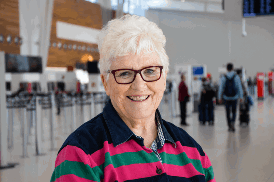 woman with striped top in airport terminal