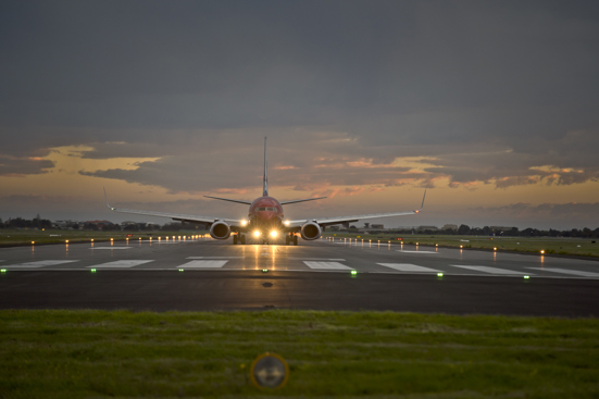 plane on runway at dusk
