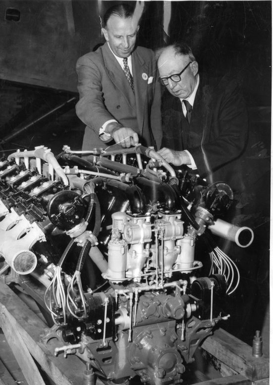 two men looking at a motor