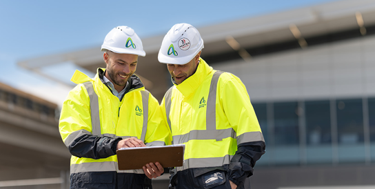 Two work men looking at some plans