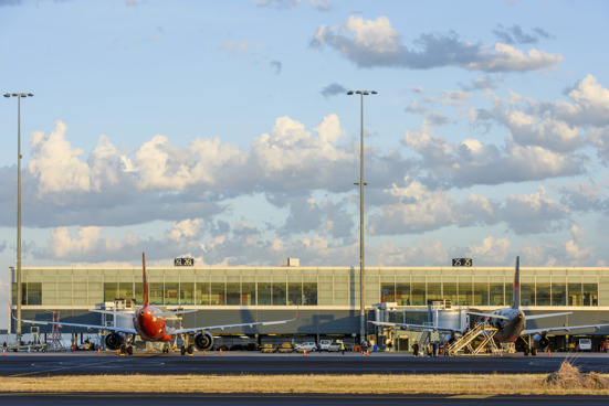 planes parked on tarmac at airport terminal