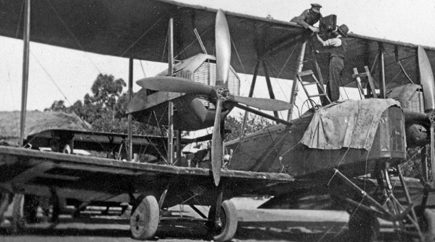 Captain Frank Hurley attaching a camera to the top of the Vimy at Northfield – Ron Blum