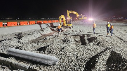 excavator digging surface of runway