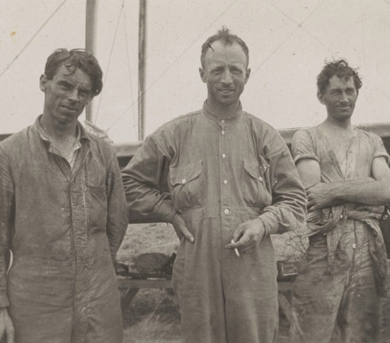 3 men standing in a row
