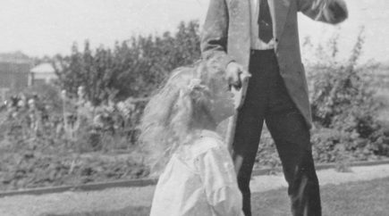 A man and a young girl in a garden looking up at something – Daryl Austin