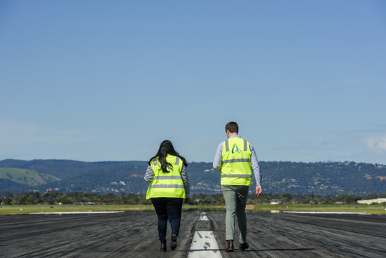 2 people in high res walking down the runway