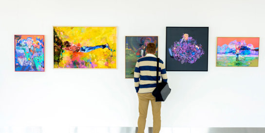 Artists lined up in front of their art during the Adelaide Airport Sense of Place art exhibition