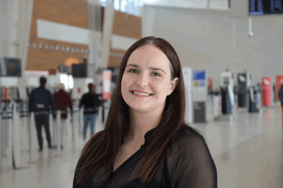 woman in black top standing in airport