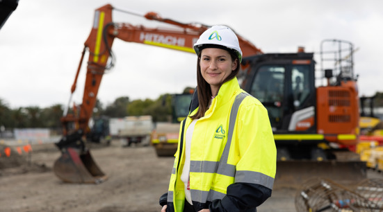 Worker in hi vis with excavator