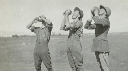 Three men standing drinking water