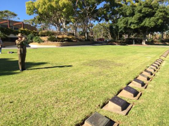 An Australian Army bugler plays The Last Post beside Wally Shiers’ gravesite