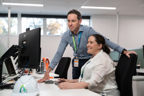 Two people looking at a computer 