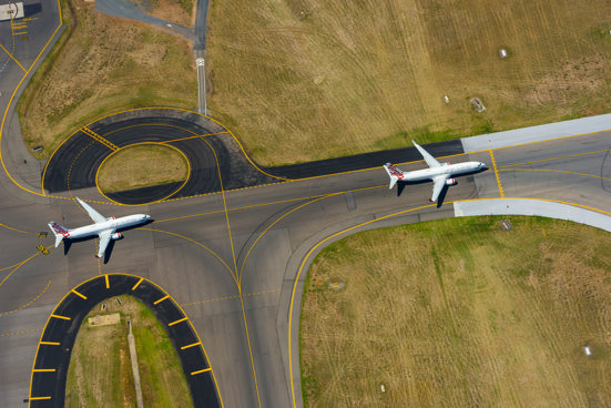 aerial photo of 2 plans on runway