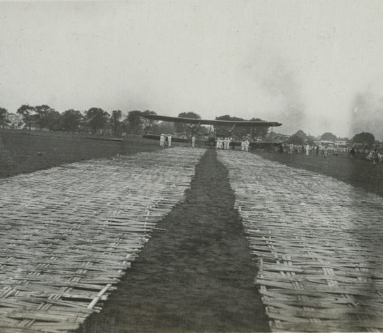 Natives were streaming in from every direction bearing sheets of bamboo matting 