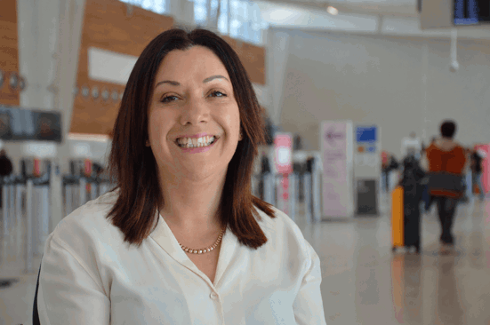 woman in white shirt standing in airport 